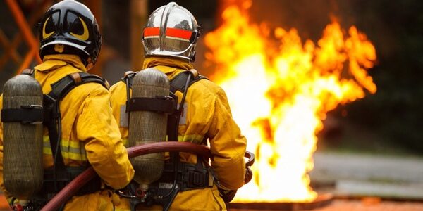 Firefighters,Team,Wearing,Full,Protective,Gear,Operate,Fire,Hose,To