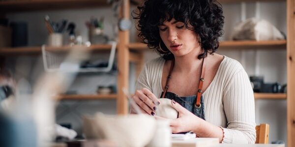 Portrait,Of,Serious,Focused,Pottery,Course,Attendee,Sitting,At,Ceramics