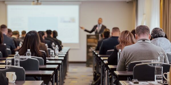 Business,Conference,Audience,Listening,To,Professional,Speaker,In,Seminar,Room.