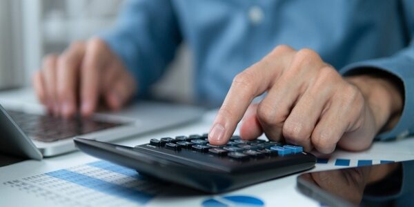 Businessman,Hands,Using,A,Calculator,To,Check,Company,Finances,And