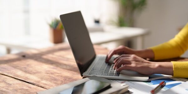 Person,Hands,Wearing,A,Yellow,Sweater,Typing,On,A,Laptop